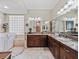 Beautiful bathroom featuring a walk-in tub, granite countertops, and a large mirror over the dual sinks at 2954 Cedar Grove Loop, The Villages, FL 32163