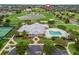 Stunning clubhouse featuring a sparkling pool, manicured landscaping, and picturesque surroundings at 2954 Cedar Grove Loop, The Villages, FL 32163