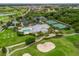 Aerial view of neighborhood amenities including a pool, tennis courts, and golf course at 2954 Cedar Grove Loop, The Villages, FL 32163