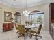 Inviting dining area with a chandelier, large windows, and stylish furnishings for comfortable living at 2954 Cedar Grove Loop, The Villages, FL 32163