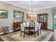 Formal dining room with modern chandelier, dark wood floors and plenty of natural light at 2954 Cedar Grove Loop, The Villages, FL 32163