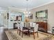 Formal dining room with dark wood floors and a view into the open concept living room at 2954 Cedar Grove Loop, The Villages, FL 32163