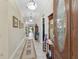 Inviting foyer features an oval glass front door, tiled floor, decorative rug, and views of the open living space at 2954 Cedar Grove Loop, The Villages, FL 32163