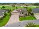 Lovely single-story home with a lush landscaped lawn and a long decorative driveway at 2954 Cedar Grove Loop, The Villages, FL 32163
