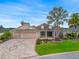 Charming single-story home with a three-car garage, lush landscaping, and a beautiful driveway at 2954 Cedar Grove Loop, The Villages, FL 32163