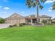 Inviting single-story home with mature landscaping, a brick driveway, and a well-manicured lawn at 2954 Cedar Grove Loop, The Villages, FL 32163