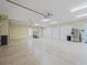 Large garage features multiple doors, a side-by-side refrigerator and ample storage space at 2954 Cedar Grove Loop, The Villages, FL 32163