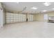 Spacious garage featuring two overhead doors and a durable speckled floor finish at 2954 Cedar Grove Loop, The Villages, FL 32163