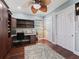 Bright home office space with hardwood floors, custom built-ins, and a large window at 2954 Cedar Grove Loop, The Villages, FL 32163