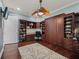 Large home office with custom shelving and a built-in desk, perfect for working from home at 2954 Cedar Grove Loop, The Villages, FL 32163