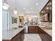 Open kitchen features granite countertops, stainless steel appliances, a center island, and ample cabinet space at 2954 Cedar Grove Loop, The Villages, FL 32163