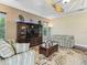 Cozy living room with striped sofas, hardwood floors and a ceiling fan at 2954 Cedar Grove Loop, The Villages, FL 32163