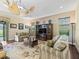 Living room featuring striped sofas, hardwood floors and a ceiling fan at 2954 Cedar Grove Loop, The Villages, FL 32163