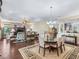 Open concept living room with plenty of natural light, comfortable furniture and a view of the formal dining area at 2954 Cedar Grove Loop, The Villages, FL 32163
