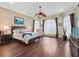 Spacious main bedroom with hardwood floors, a ceiling fan, and plenty of natural light at 2954 Cedar Grove Loop, The Villages, FL 32163