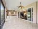 Covered patio with an outdoor kitchen and sliding doors leading to the living room at 2954 Cedar Grove Loop, The Villages, FL 32163