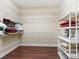 Bright walk-in closet featuring custom shelving and ample storage space for clothing and accessories at 2954 Cedar Grove Loop, The Villages, FL 32163