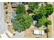 An aerial view of a neighborhood with mature trees, lawns, and residential homes on a sunny day at 307 Water Shore Dr, Leesburg, FL 34748