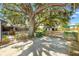 Large backyard with mature shade trees, pool and detached garage at 307 Water Shore Dr, Leesburg, FL 34748