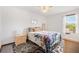 Cozy bedroom featuring a ceiling fan, a patterned rug, and natural light through the window at 307 Water Shore Dr, Leesburg, FL 34748