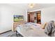 Bright bedroom showcasing natural light, a ceiling fan, and closet with wood trim at 307 Water Shore Dr, Leesburg, FL 34748
