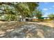 Detached garage with carport near backyard with mature shade trees at 307 Water Shore Dr, Leesburg, FL 34748