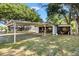Detached garage and carport offer ample space for parking and storage at 307 Water Shore Dr, Leesburg, FL 34748