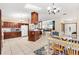 Bright kitchen with a breakfast bar, white appliances, and an open layout to the dining area and living room at 307 Water Shore Dr, Leesburg, FL 34748