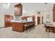 Bright eat-in kitchen with wood cabinetry, island seating and views of the backyard at 307 Water Shore Dr, Leesburg, FL 34748