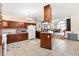 Spacious kitchen with dark wood cabinets, a breakfast bar, and clear sightlines to the living area at 307 Water Shore Dr, Leesburg, FL 34748