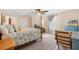 Comfortable main bedroom with a four-poster bed, sitting area, and views to the backyard at 307 Water Shore Dr, Leesburg, FL 34748