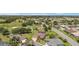 Expansive aerial view of a home with a pool, golf course views, and lush landscaping in a peaceful community at 3319 Barrington Ct, The Villages, FL 32162