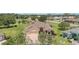 Aerial view showcasing a well-maintained single-story home with a brick driveway and lush landscaping at 3319 Barrington Ct, The Villages, FL 32162