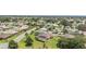 Scenic aerial view of homes in a well-planned community, featuring lush landscaping and a tranquil pond at 3319 Barrington Ct, The Villages, FL 32162