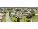 An aerial view of a residential community with golf course, revealing manicured lawns and diverse home styles at 3319 Barrington Ct, The Villages, FL 32162