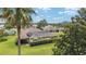 Aerial view of a beautiful home with a screened pool, lush landscaping, and a well-maintained lawn at 3319 Barrington Ct, The Villages, FL 32162