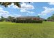 Manicured backyard with lush green grass and privacy hedge at 3319 Barrington Ct, The Villages, FL 32162