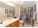 Comfortable bathroom with a shower, vanity, and soft patterned shower curtain, offering practical comfort at 3319 Barrington Ct, The Villages, FL 32162