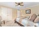 Comfortable bedroom with a ceiling fan, closet space, and neutral décor for a peaceful retreat at 3319 Barrington Ct, The Villages, FL 32162