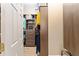 Spacious walk-in closet with custom wood shelving, drawers, and ample storage space for organized living at 3319 Barrington Ct, The Villages, FL 32162