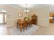 Cozy dining room with a wooden table, chairs, and a decorative cabinet at 3319 Barrington Ct, The Villages, FL 32162