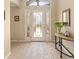Bright foyer featuring tile flooring and a decorative glass front door with sidelights at 3319 Barrington Ct, The Villages, FL 32162