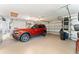 Wide garage featuring a vibrant SUV, ample storage, ceiling fan, and automatic doors at 3319 Barrington Ct, The Villages, FL 32162