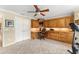 Spacious home office featuring custom wood built-ins, providing ample storage and workspace at 3319 Barrington Ct, The Villages, FL 32162