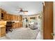 Bright home office featuring custom wooden built-ins, a cozy seating area, and a ceiling fan at 3319 Barrington Ct, The Villages, FL 32162