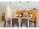 An open kitchen features stainless appliances, granite counters, and a breakfast bar with pendant lighting at 3319 Barrington Ct, The Villages, FL 32162