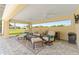 Inviting lanai featuring neutral toned furniture, ceiling fans, brick floors, and an elegant design at 3319 Barrington Ct, The Villages, FL 32162