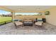 Neutral lanai featuring brick floors, comfortable seating, ceiling fans, and a picturesque view of the outdoors at 3319 Barrington Ct, The Villages, FL 32162