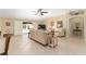 Spacious living room with tile floors and sliding glass doors to the pool area at 3319 Barrington Ct, The Villages, FL 32162