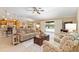 Open floor plan connecting the living room to the kitchen and pool area at 3319 Barrington Ct, The Villages, FL 32162